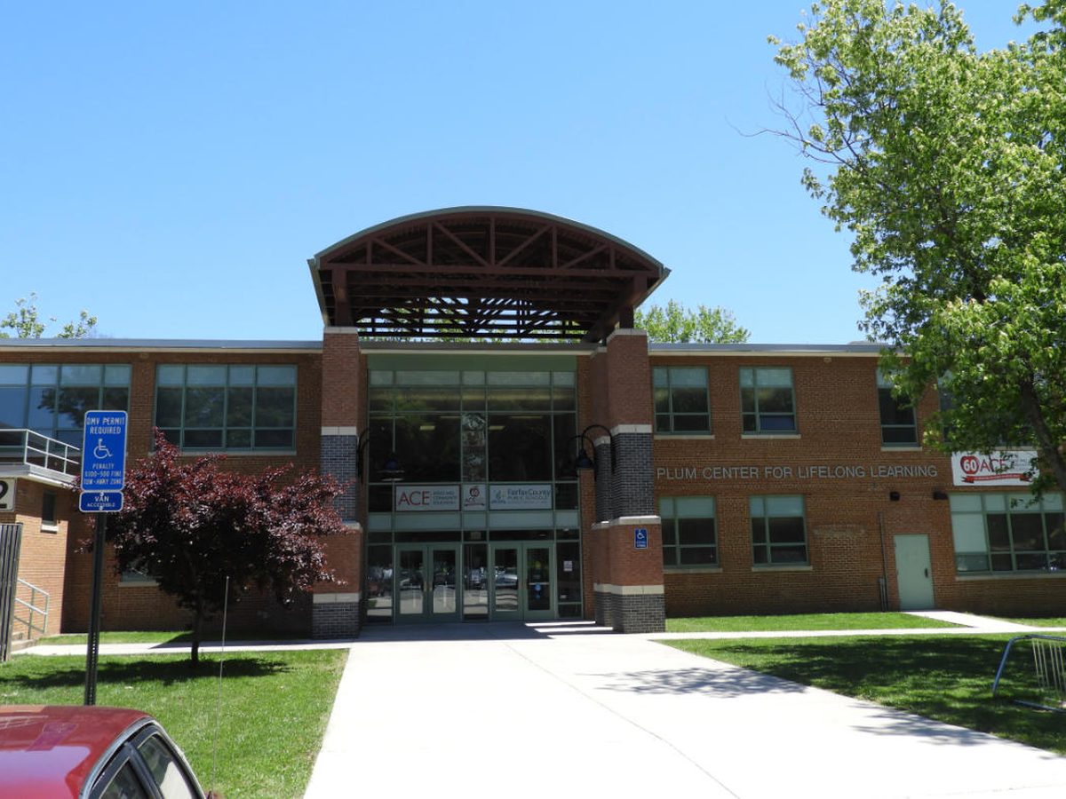 Brick and glass entry of the FCPS Edsal Park Community Education Center with arched canopy