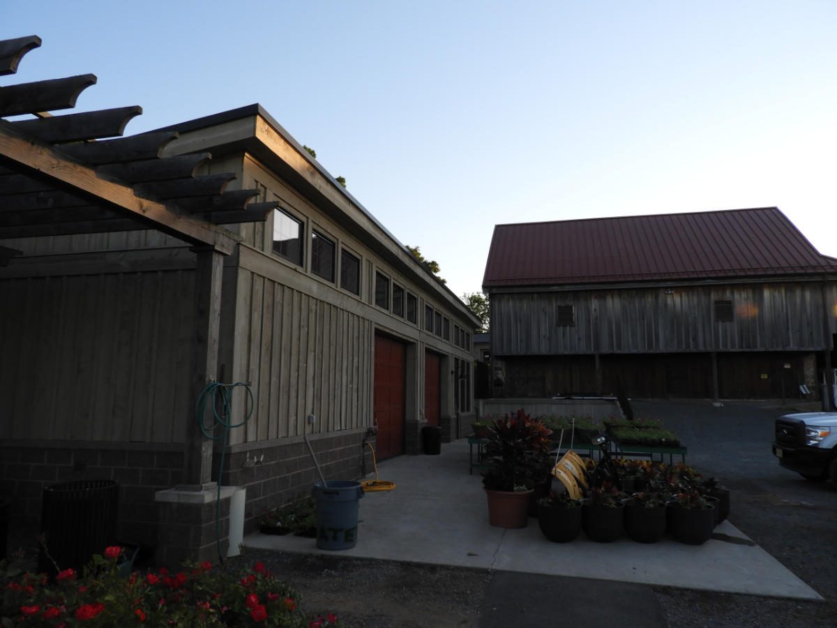 Restored Ida Lee barn and new maintenance facility with red roof in Leesburg, Virginia
